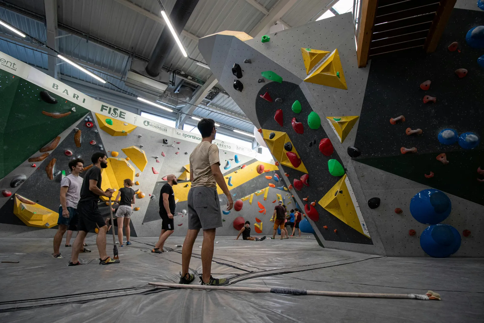 Climbers on a colourful indoor bouldering wall